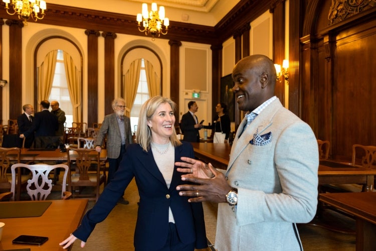 Woodin chats with U of T Chancellor Wes Hall&nbsp;following a meeting of Governing Council on March 26, 2025.