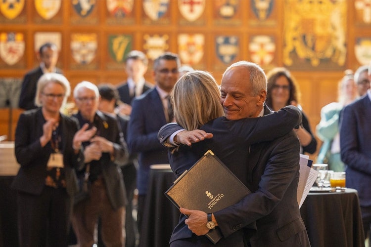 Melanie Woodin embraces Meric Gertler at Hart House
