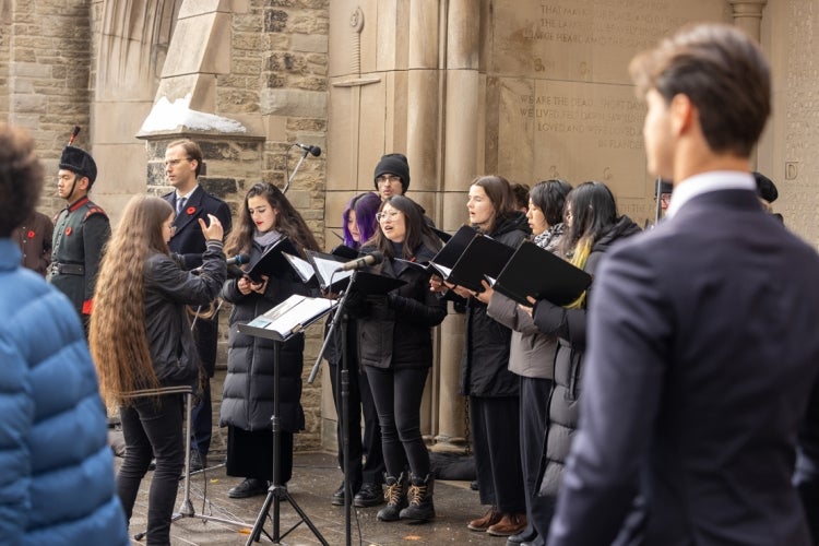 the choir is singing at the remembrance day ceremony