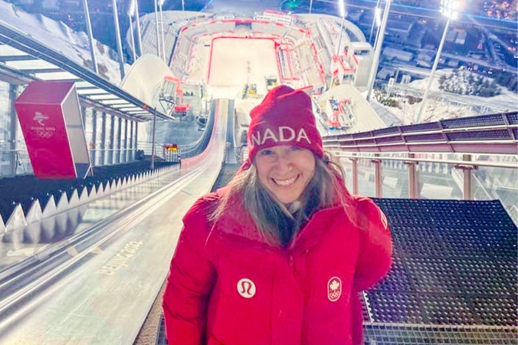 Mireille Landry stands on top of a ski jump at the milano olympics