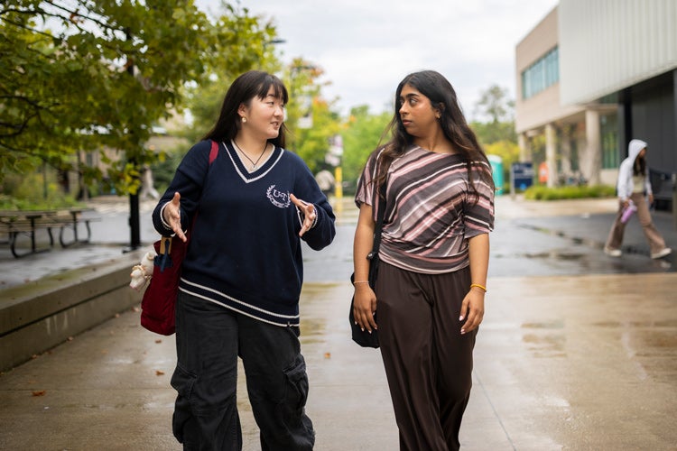 Jacelynn Su (L) and Abeeha Shuja walk along the UTM campus